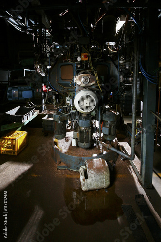 Old factory equipment including motors fixed in a room © JRstock