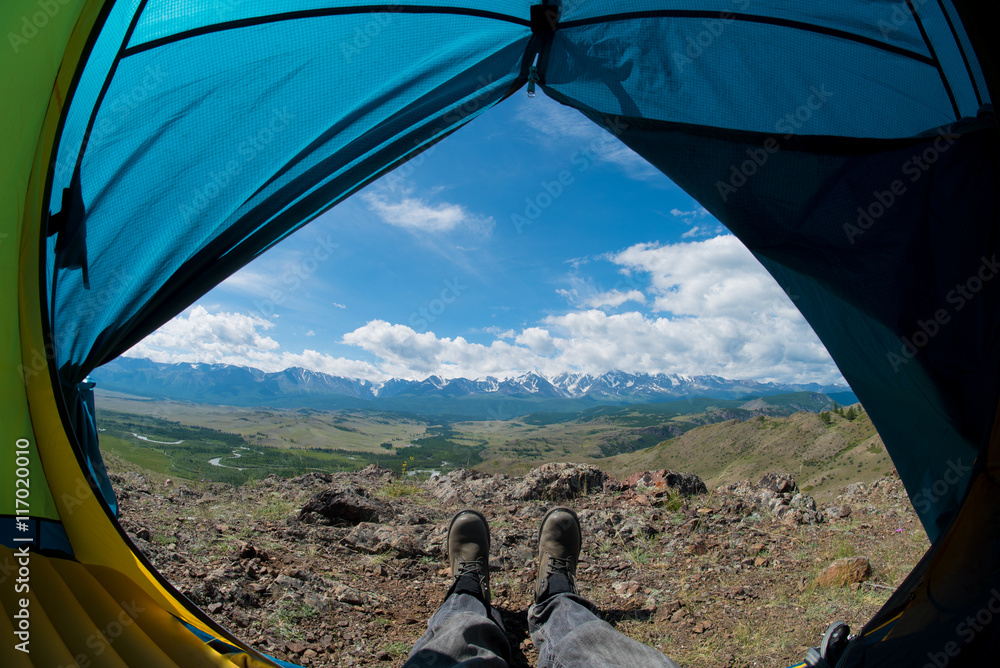 feet in the shoes against the backdrop of the mountains