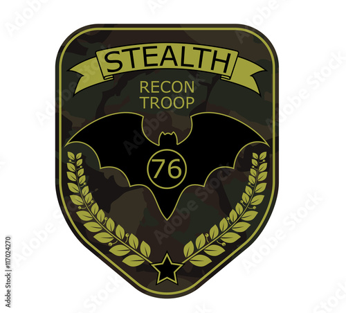 Recon troop military emblem patch with bat, ribbon, star and branch. Army chevron logo on camouflage background