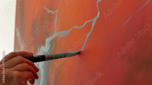 An artist is showing some techniques of painting