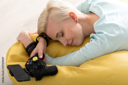Woman sleeping with game controller
