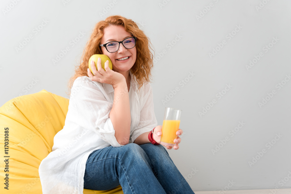 Cheerful woman sitting in the chair Cheerful woman sitting in the chair