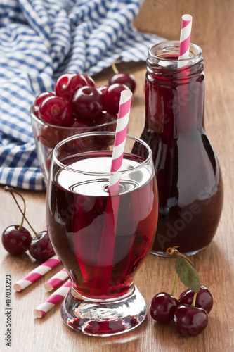Cherry juice drink / Fresh cherry juice and cherry fruit delicious summer drink on wooden background