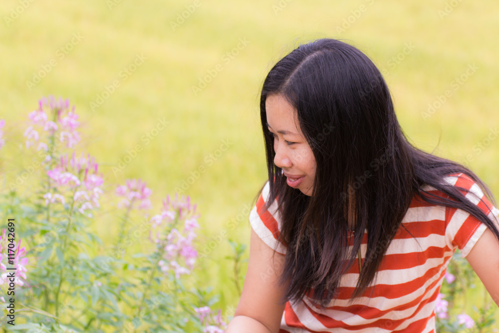 asian woman look flower at rice field in Thailand asian woman look flower at rice field in Thailand