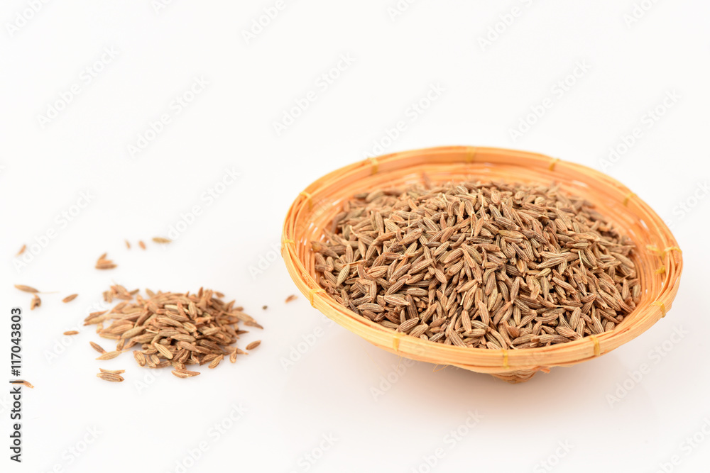 Cumin seeds, spices, medicinal properties in a basket on a white background. Cumin seeds, spices, medicinal properties in a basket on a white background.