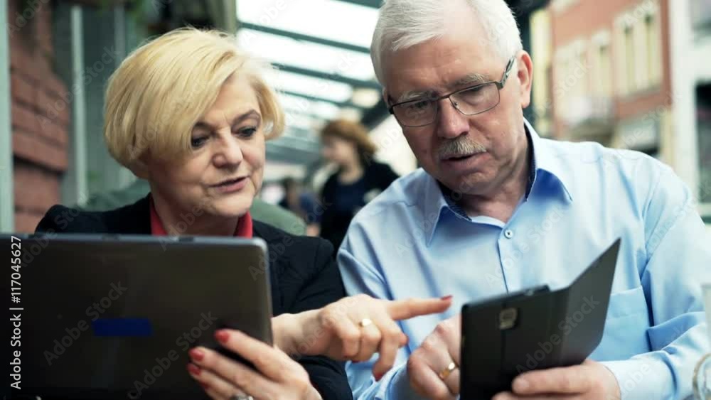 Mature couple using smartphone and tablet computer sitting in cafe in the city
Mature couple using smartphone and tablet computer sitting in cafe in the city