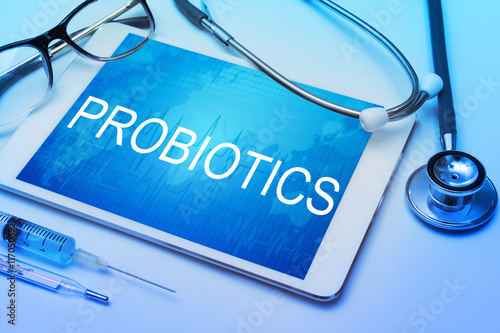 Probiotics word on tablet screen with medical equipment on background