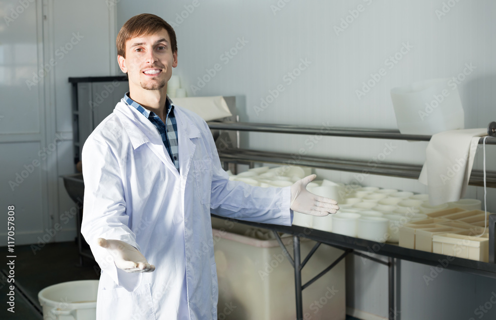 Young man on the dairy manufacture