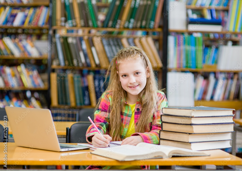 teen girl working in the library