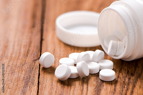round pills on wood table,medicine