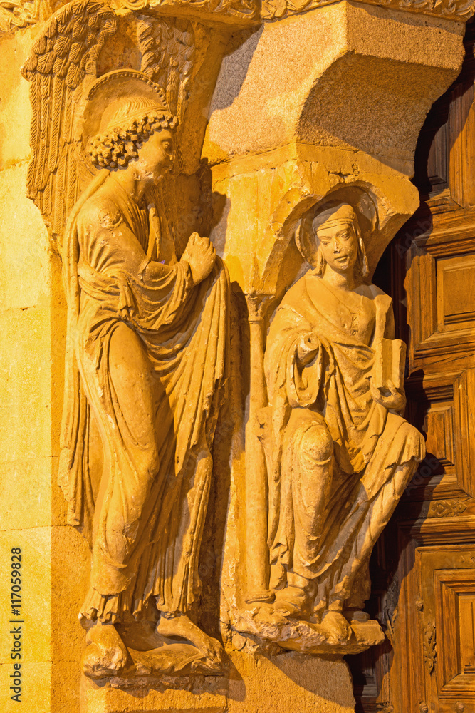 AVILA, SPAIN, APRIL - 19, 2016: The Annunciation sulptuere on the left part of romanesque south portal of Basilica de San Vicente with the apostles (1130).