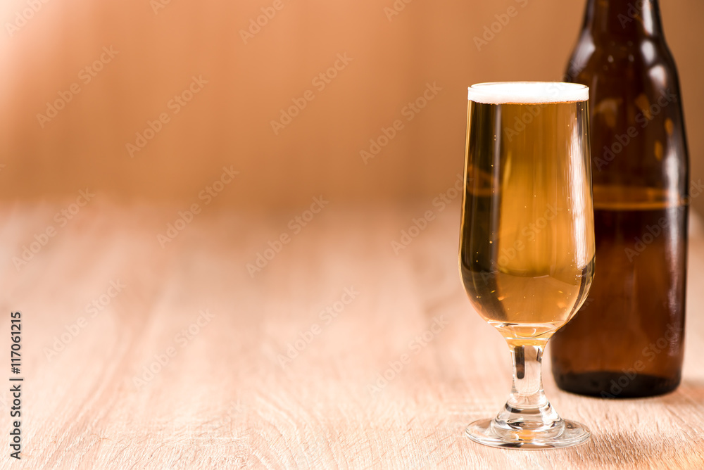 beer in glass on wood table beer in glass on wood table
