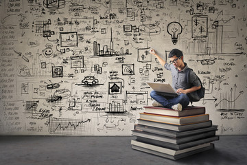 Young businessman writing schemes