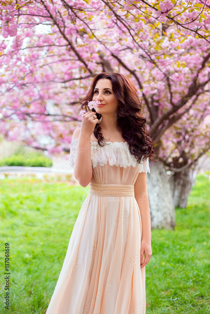beautiful spring walk in the woods among the cherry blossom in Aprila lady in a long dress pastel , creative computer colors, fashionable toning beautiful spring walk in the woods among the cherry blossom in Aprila lady in a long dress pastel , creative computer colors, fashionable toning