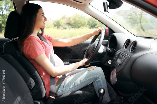 Pregnant woman driving car....