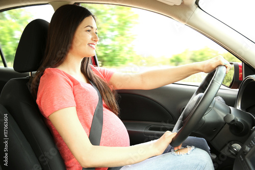 Pregnant woman driving car....