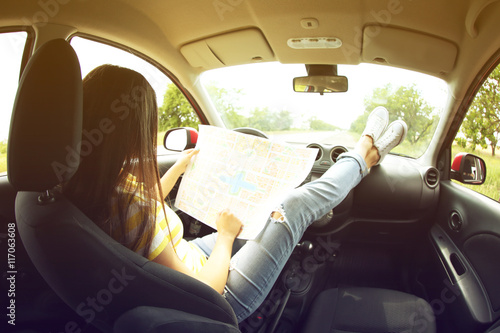 Woman sitting with road map in car © Africa Studio