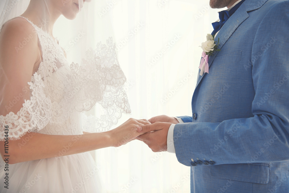 Fototapeta premium Bride and groom hands, closeup