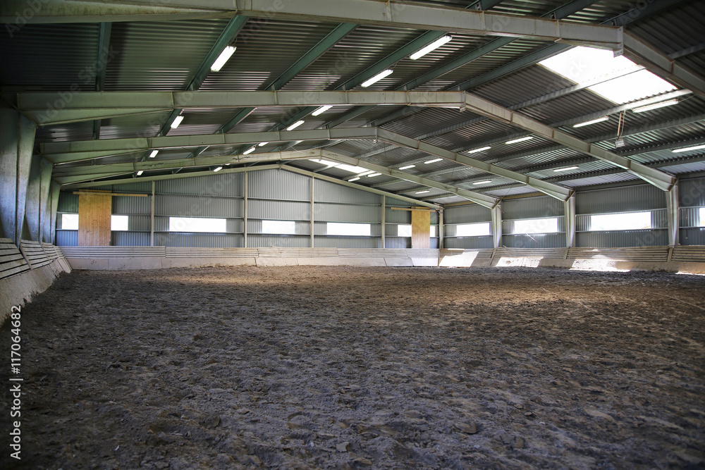 Riding hall with sandy covering without people Riding hall with sandy covering without people