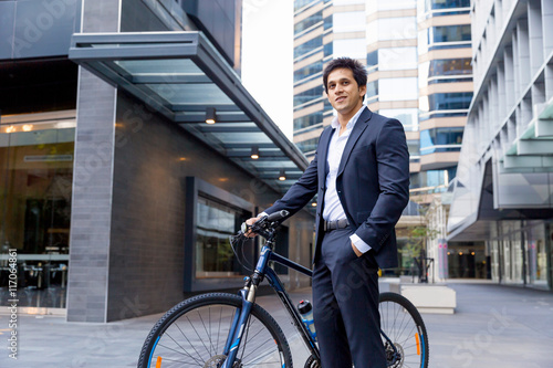 Successful businessman riding bicycle