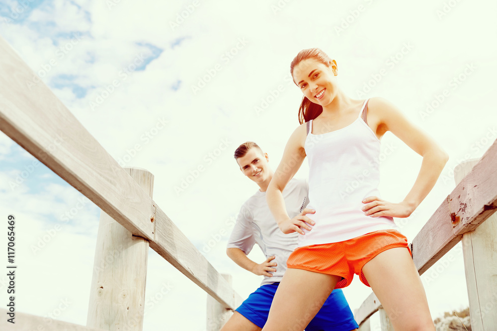 Runners. Young couple exercising on beach
