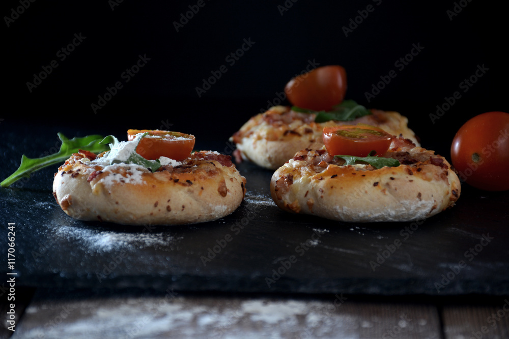 Mini Pizzas Over a Black Board Mini Pizzas Over a Black Board