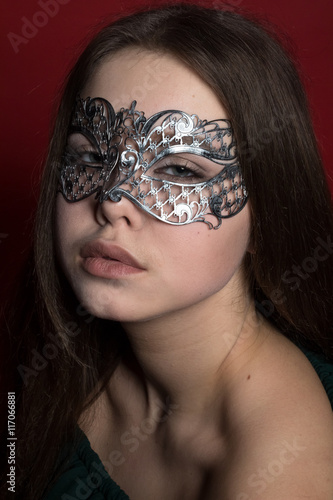 a girl in a Venetian mask