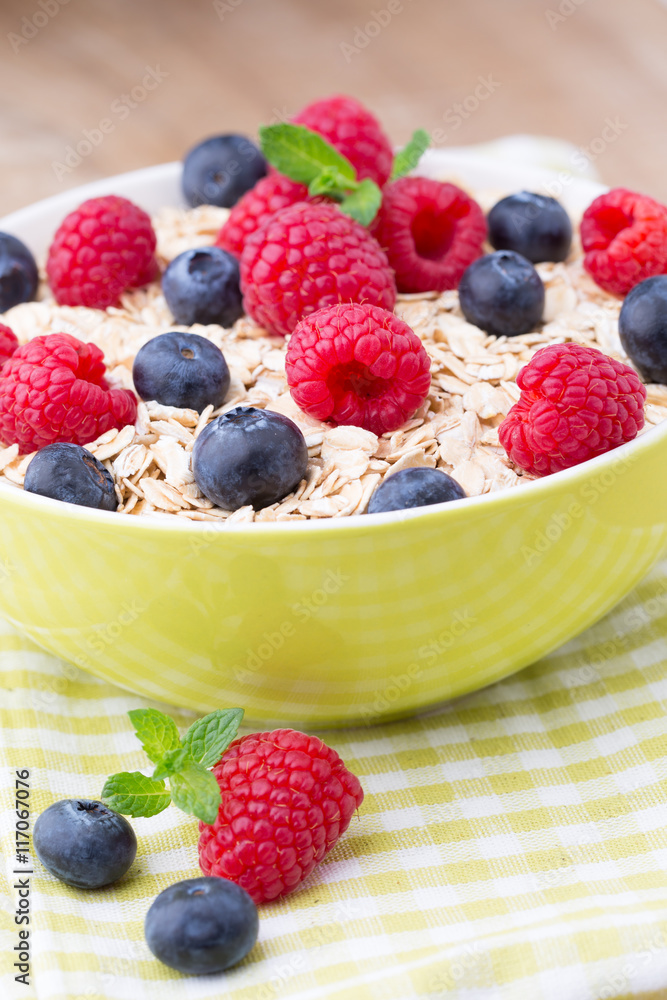 Oatmeal porridge with berries. Raspberries and blueberries. Oatmeal porridge with berries. Raspberries and blueberries.
