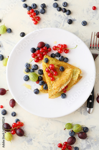 Summer crepe with berries on white plate