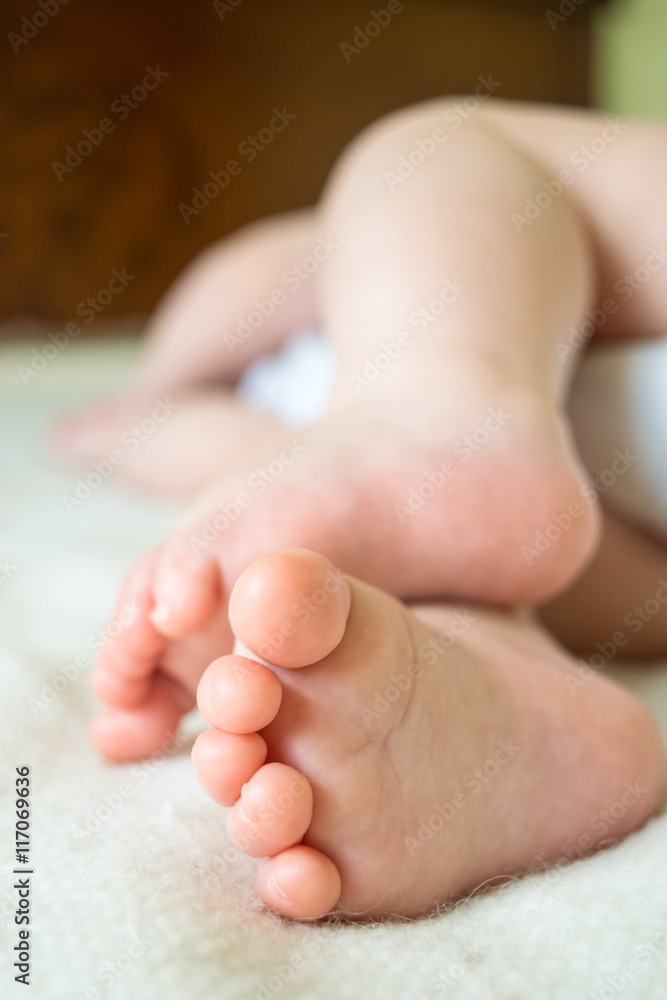 An adorable baby is sleeping on a bad. Foots of a sleeping baby. An adorable baby is sleeping on a bad. Foots of a sleeping baby.