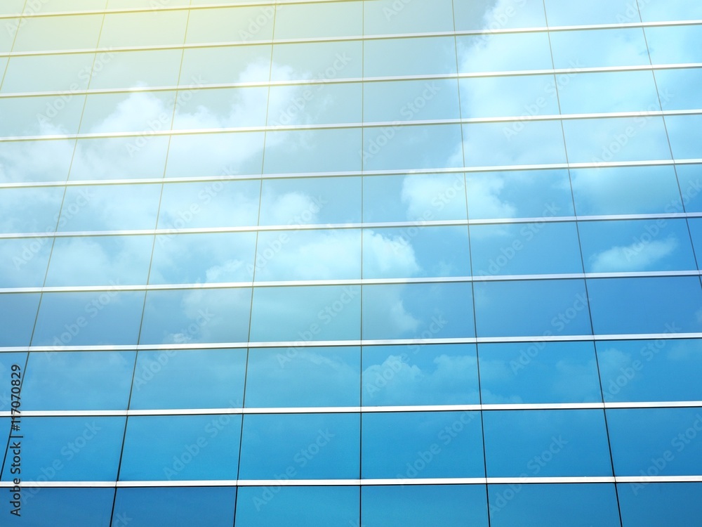 Clouds reflected in windows of modern building Clouds reflected in windows of modern building