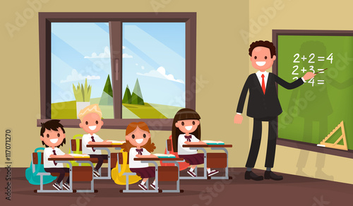Math lesson. A teacher with pupils in primary school classroom.