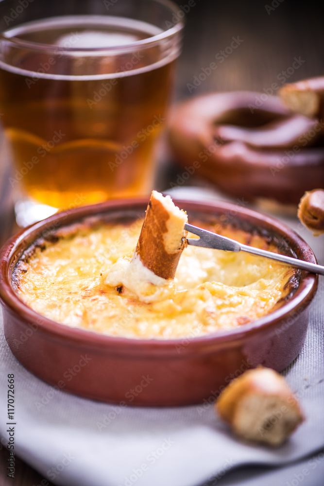 worming cheese fondue with pretzel at winter worming cheese fondue with pretzel at winter