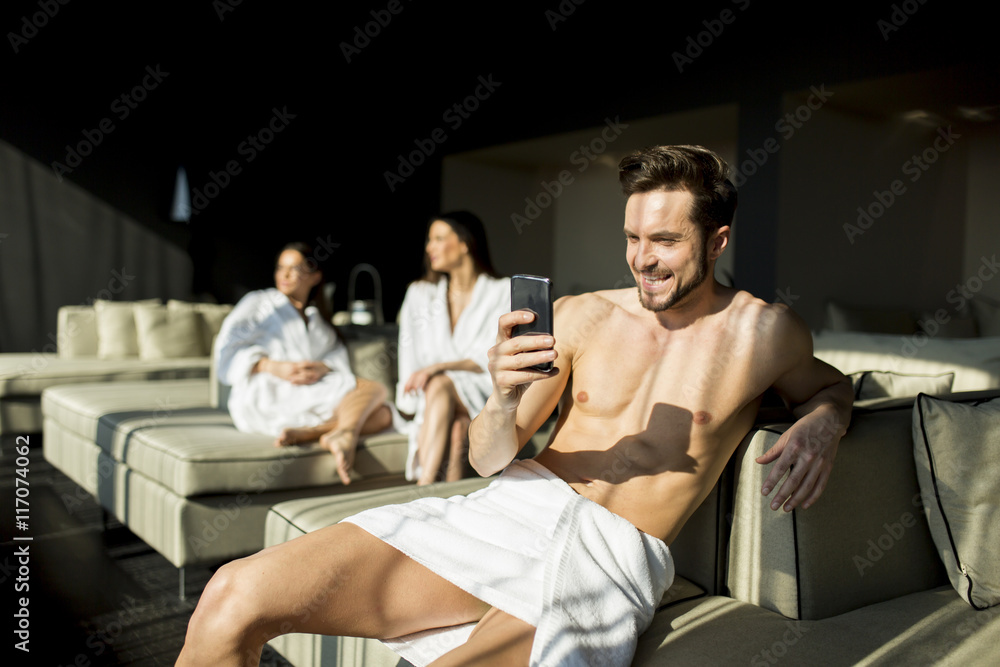 Young man in the room with mobile hone