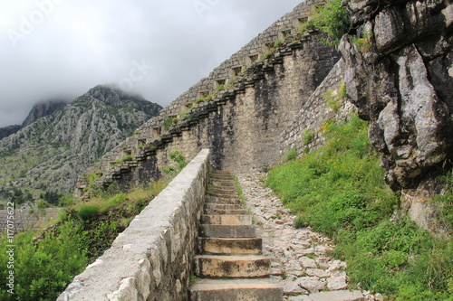 A long stone staircase with high steps rising up to the clouds