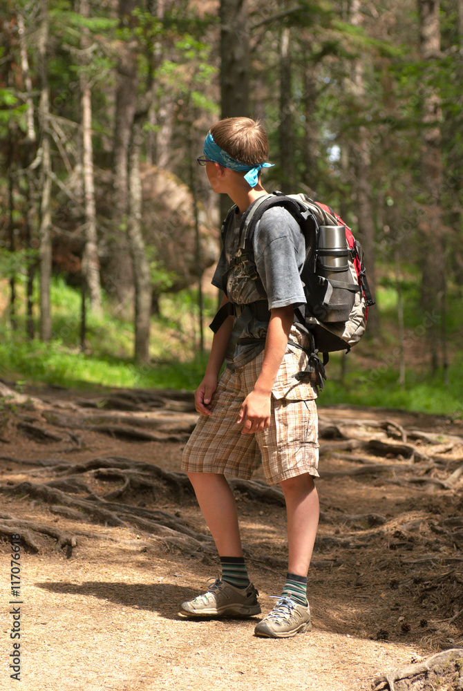 Hiking boy with a backpack.