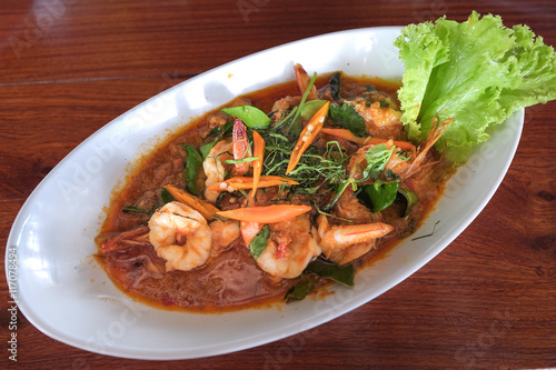 Curry-fried shrimps in coconut milk and chilli by Thai style.