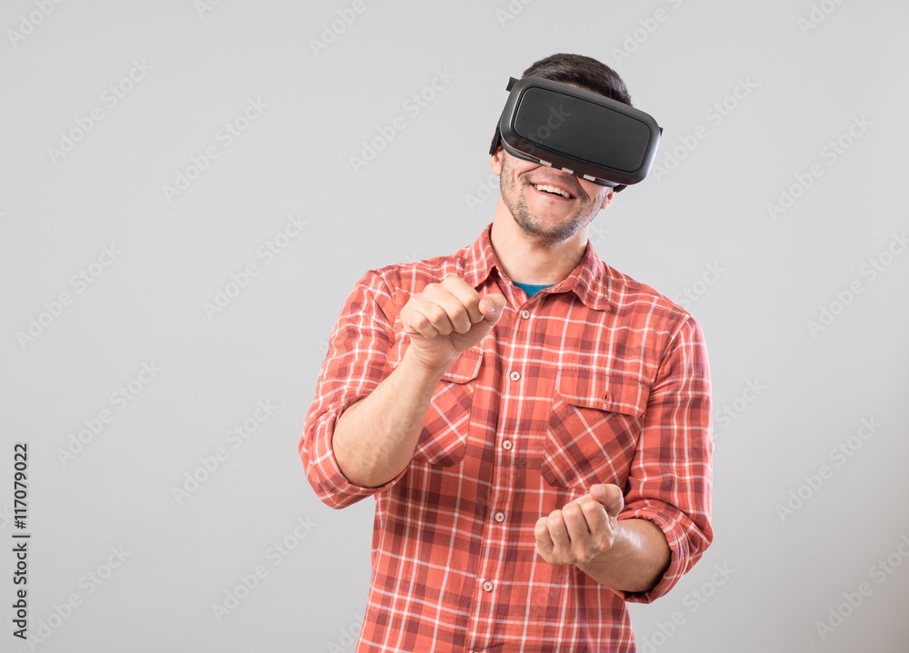Man with virtual reality glasses paying car simulator Man with virtual reality glasses paying car simulator