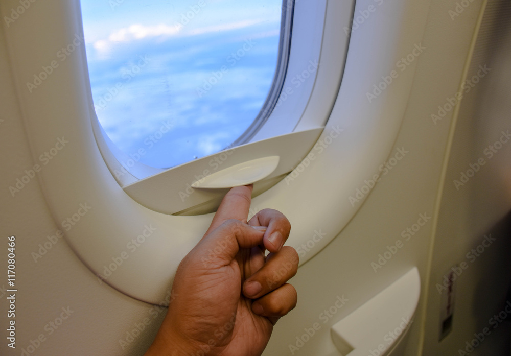 Fototapeta premium hand open plane windows with sky outside
