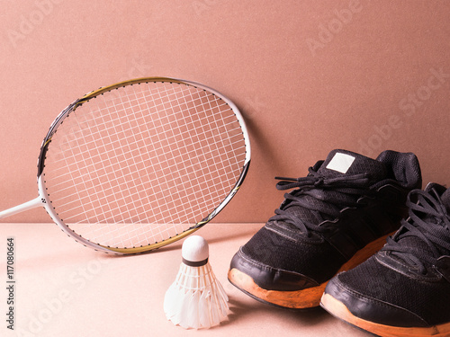 sports set of black orange sport shoes and shuttlecocks with two