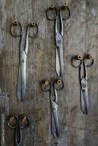 five pairs of old scissors on a wooden photo