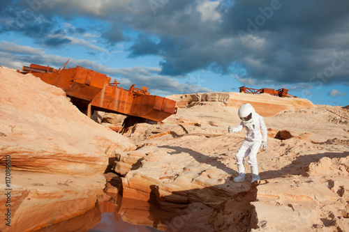Fototapeta Naklejka Na Ścianę i Meble -  futuristic astronaut on another planet, Mars. image with the effect of toning