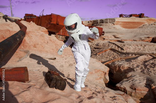 Fototapeta Naklejka Na Ścianę i Meble -  futuristic astronaut on another planet, Mars. image with the effect of toning