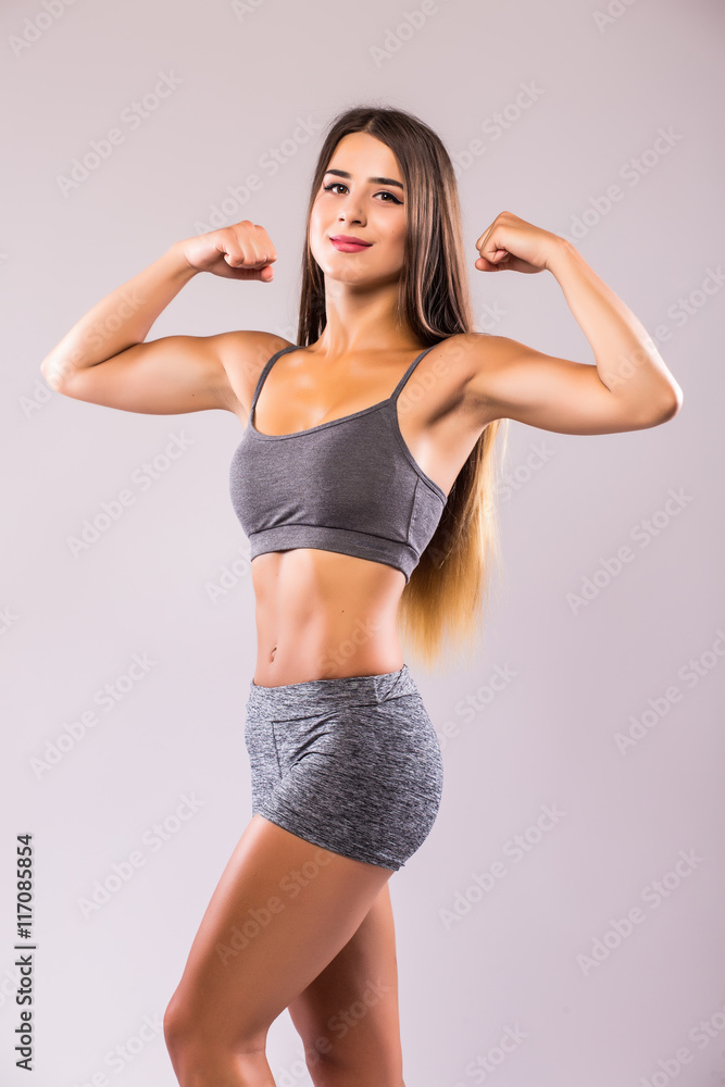 Obraz premium Athlete girl demonstrate power in hands