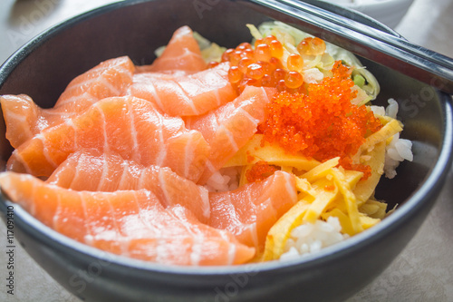 Raw salmon on cooked rice