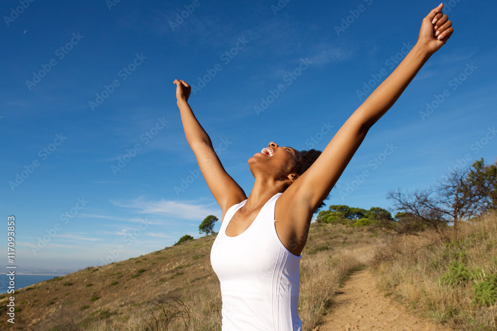 Overjoyed woman outdoors with her arms wide open Overjoyed woman outdoors with her arms wide open