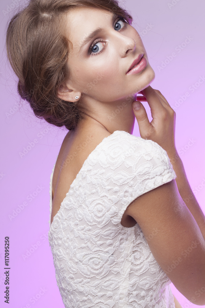 pretty young woman in white dress on the pink background