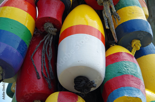Brightly colored boating buoys bunched and hanging