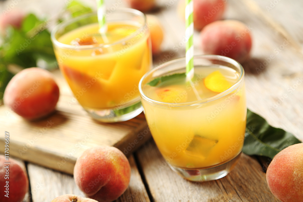 Glasses of peach juice on grey wooden table Glasses of peach juice on grey wooden table