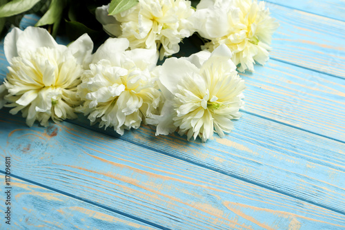 Bouquet of white peony flowers on wooden table